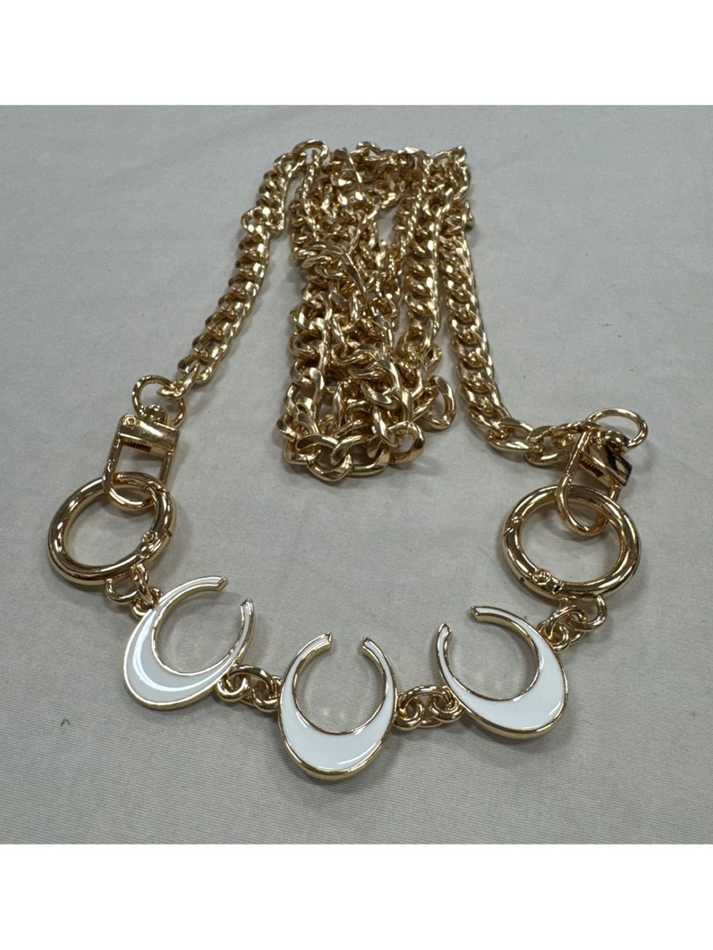 Gold Crossbody Chain with White Enamel Crescent or “C” Accents.